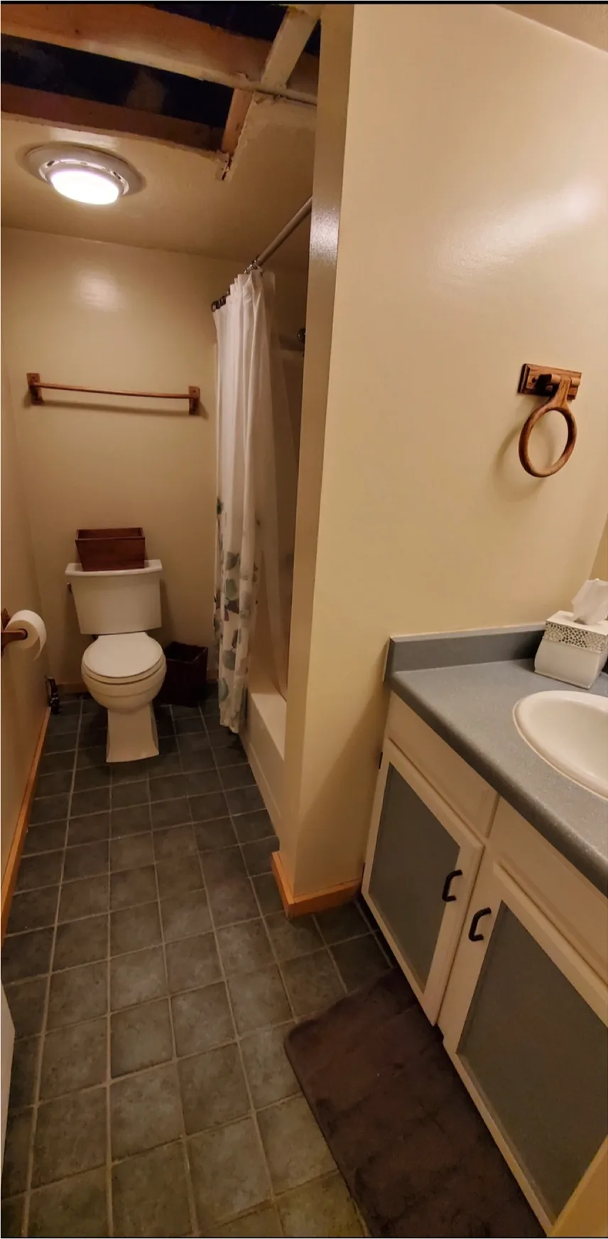 Before: bathroom remodel in Utah, from a dated basement bathroom to a glass shower with a floating wood vanity